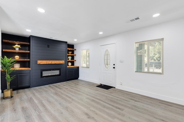 438 E Cortland Ave, Fresno, CA 93704 - entryway featuring a large fireplace, light wood-style floors, and recessed lighting