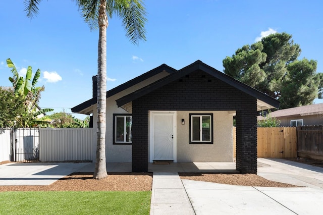 438 E Cortland Ave, Fresno, CA 93704 - view of front of property with a gate and stucco siding