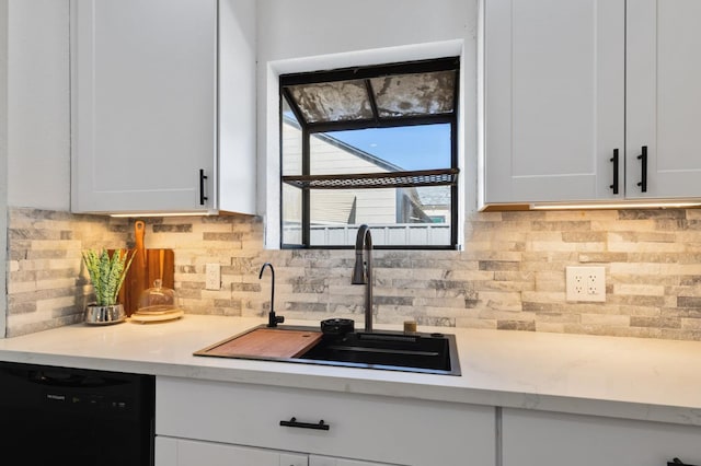 438 E Cortland Ave, Fresno, CA 93704 - kitchen with black dishwasher, light countertops, white cabinetry, and decorative backsplash