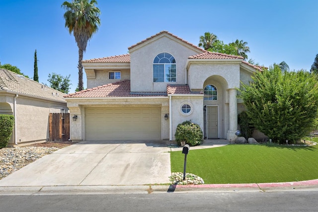 9544 N Whitehouse Dr, Fresno, CA 93720 - mediterranean / spanish house featuring stucco siding, a tile roof, and driveway