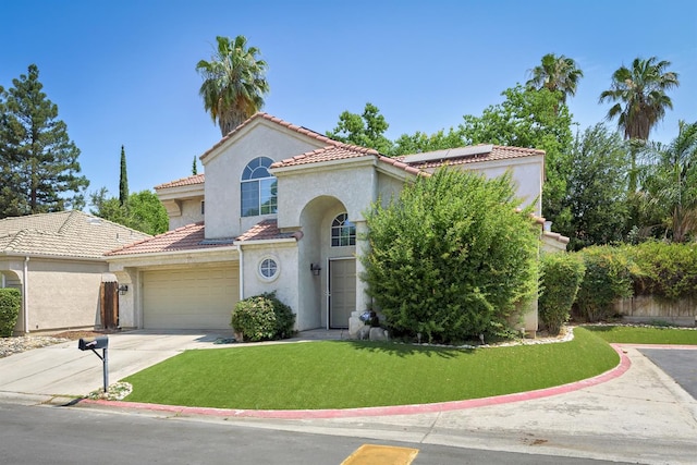 9544 N Whitehouse Dr, Fresno, CA 93720 - mediterranean / spanish house with a tiled roof, solar panels, stucco siding, a front yard, and driveway