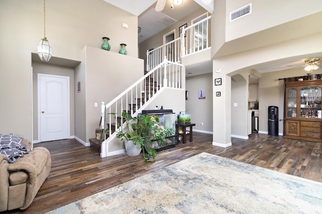 9544 N Whitehouse Dr, Fresno, CA 93720 - living area featuring a ceiling fan, wood finished floors, a high ceiling, stairs, and arched walkways