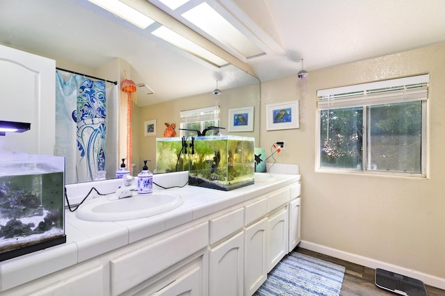 9544 N Whitehouse Dr, Fresno, CA 93720 - bathroom featuring double vanity and wood finished floors