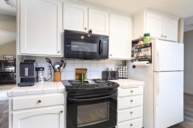 9544 N Whitehouse Dr, Fresno, CA 93720 - kitchen featuring black appliances, tile counters, wood finished floors, and white cabinetry