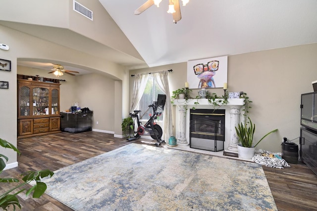 9544 N Whitehouse Dr, Fresno, CA 93720 - living area featuring ceiling fan, a premium fireplace, vaulted ceiling, wood finished floors, and arched walkways