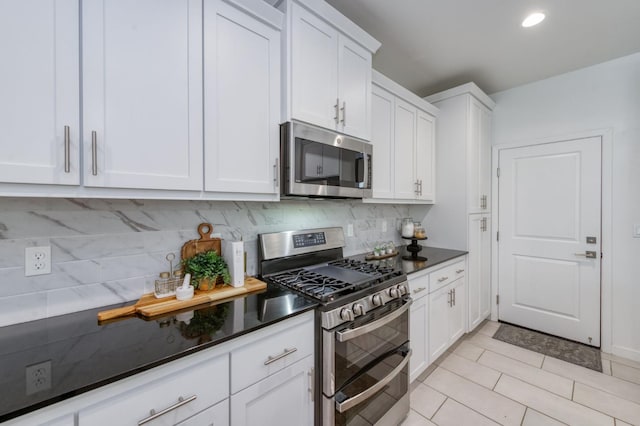 4670 Terrace Rd, Madera, CA 93636 - kitchen with appliances with stainless steel finishes, white cabinetry, backsplash, light tile patterned flooring, and recessed lighting