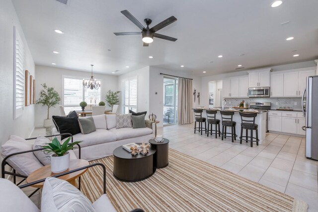 4670 Terrace Rd, Madera, CA 93636 - living room featuring recessed lighting, a ceiling fan, a chandelier, and light tile patterned flooring