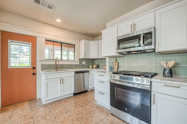 730 E Yale Ave, Fresno, CA 93704 - kitchen featuring appliances with stainless steel finishes, tasteful backsplash, white cabinetry, and recessed lighting
