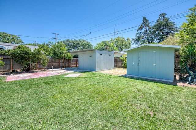 730 E Yale Ave, Fresno, CA 93704 - fenced backyard with a storage unit and a patio area