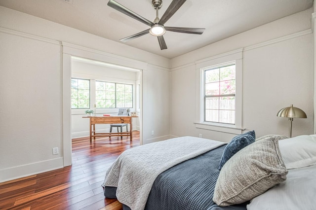 730 E Yale Ave, Fresno, CA 93704 - bedroom featuring multiple windows, hardwood / wood-style flooring, a desk, and a ceiling fan