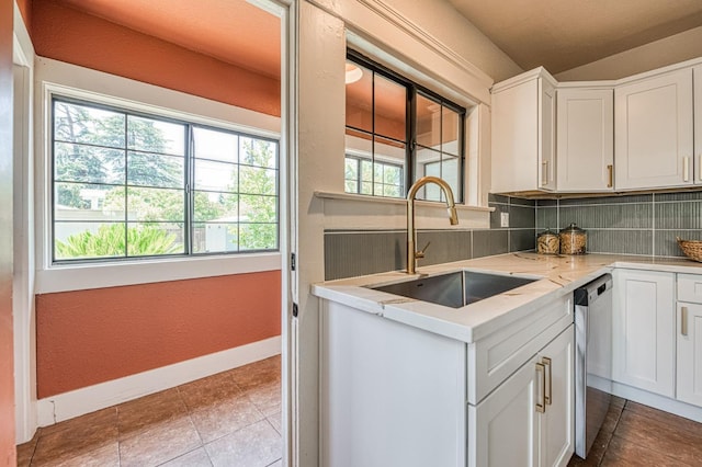 730 E Yale Ave, Fresno, CA 93704 - kitchen featuring decorative backsplash, stainless steel dishwasher, white cabinetry, light stone countertops, and tile patterned floors