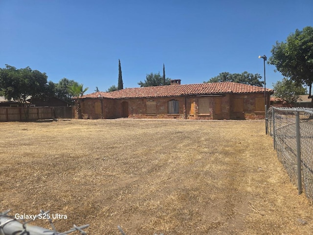 4933 E Tulare Ave, Fresno, CA 93727 - rear view of property featuring a tiled roof and stucco siding