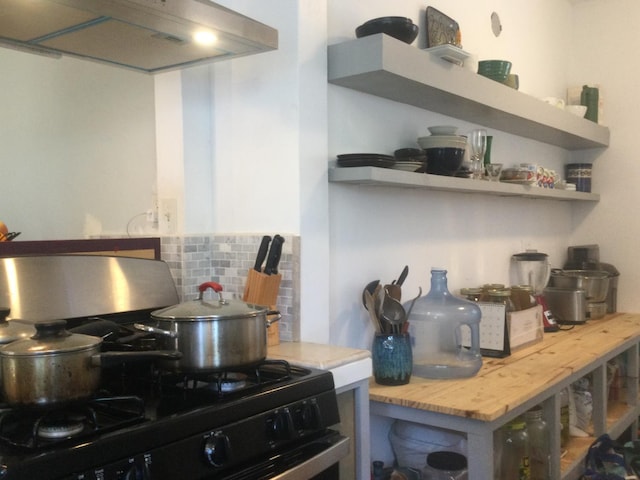 411 E Fountain Way, Fresno, CA 93704 - kitchen with gas stove, range hood, backsplash, open shelves, and light countertops