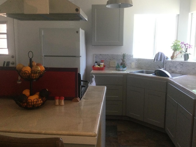 411 E Fountain Way, Fresno, CA 93704 - kitchen featuring extractor fan, tasteful backsplash, light countertops, and freestanding refrigerator