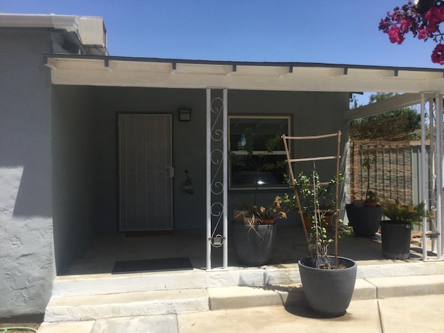 411 E Fountain Way, Fresno, CA 93704 - property entrance featuring stucco siding