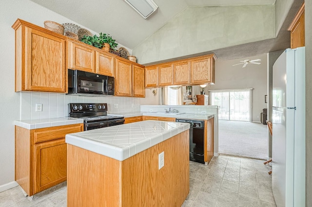 2869 E Brandon Ln, Fresno, CA 93720 - kitchen featuring black appliances, a kitchen island, a peninsula, tile countertops, and tasteful backsplash