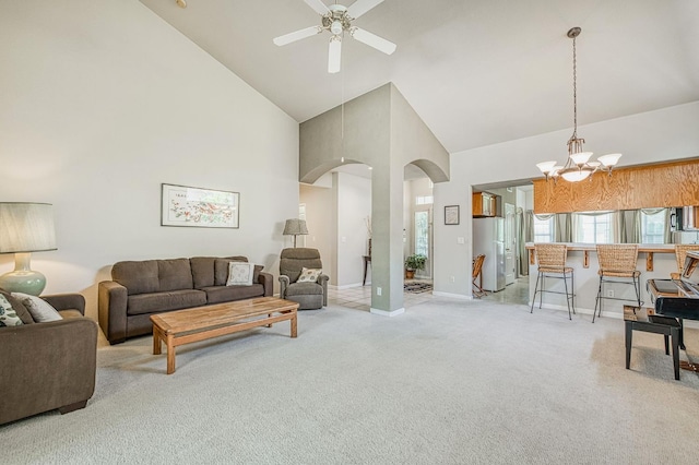 2869 E Brandon Ln, Fresno, CA 93720 - carpeted living area featuring high vaulted ceiling, arched walkways, ceiling fan, and a chandelier