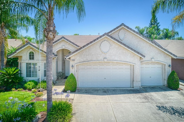 2869 E Brandon Ln, Fresno, CA 93720 - view of front of home featuring a garage, stucco siding, and concrete driveway