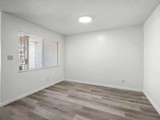4629 N Fisher St, Fresno, CA 93726 - unfurnished room featuring a textured ceiling and wood finished floors
