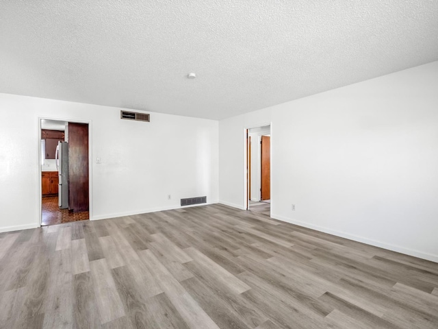 4629 N Fisher St, Fresno, CA 93726 - unfurnished room featuring wood finished floors and a textured ceiling