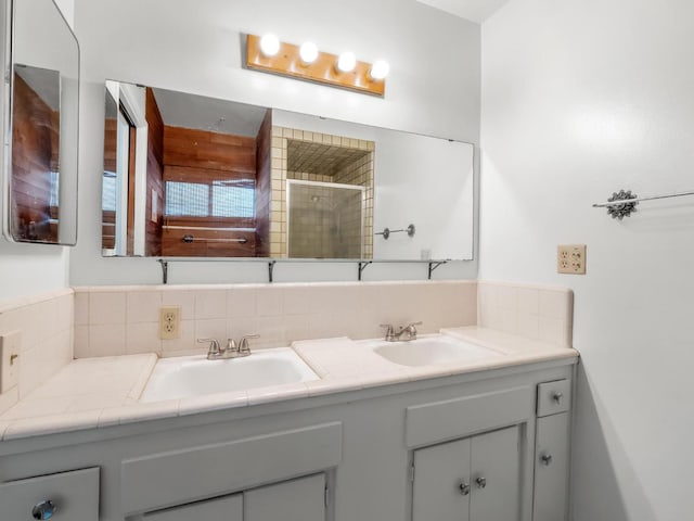 4629 N Fisher St, Fresno, CA 93726 - full bathroom featuring double vanity, tasteful backsplash, and tiled shower