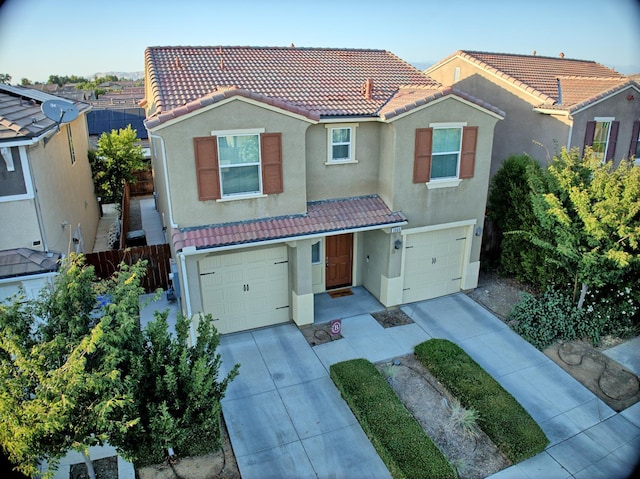 3869 Griffith Ave, Clovis, CA 93619 - view of front of house featuring a garage, a tiled roof, concrete driveway, and stucco siding