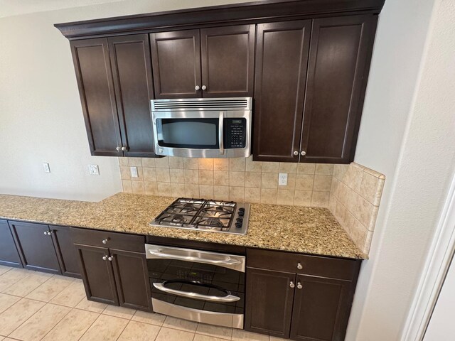 4074 Heritage Ln, Clovis, CA 93619 - kitchen with stainless steel appliances, decorative backsplash, light tile patterned floors, and light stone countertops