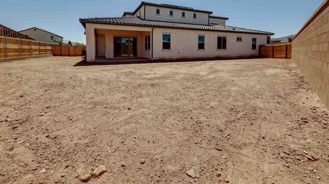 925 Talus Way S, Madera, CA 93636 - back of house featuring a tiled roof, stucco siding, a fenced backyard, and a patio