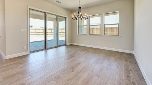 925 Talus Way S, Madera, CA 93636 - spare room with a chandelier and light wood-type flooring