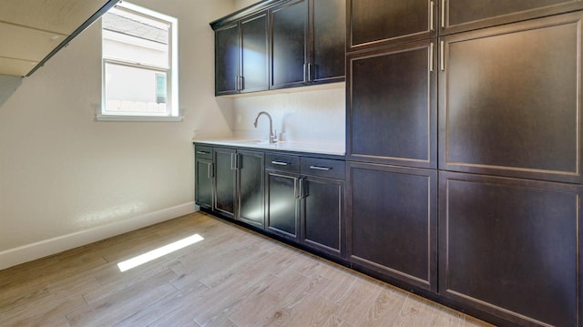 925 Talus Way S, Madera, CA 93636 - kitchen with light wood-type flooring, dark brown cabinetry, and light countertops