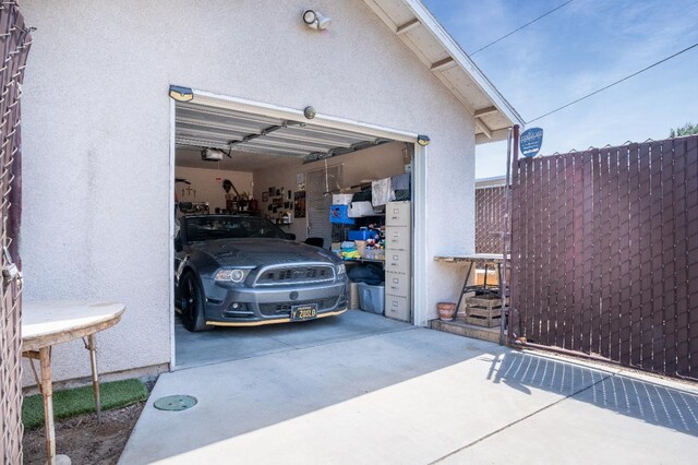 51 E Tuolumne St, Fresno, CA 93706 - garage featuring a garage door opener and concrete driveway