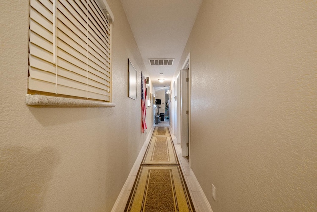 51 E Tuolumne St, Fresno, CA 93706 - hallway featuring baseboards and a textured wall
