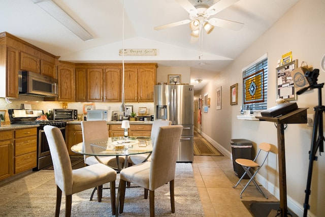 51 E Tuolumne St, Fresno, CA 93706 - dining area featuring vaulted ceiling, ceiling fan, and light tile patterned floors