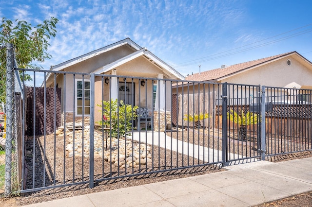 51 E Tuolumne St, Fresno, CA 93706 - view of front of house with a fenced front yard, stucco siding, a gate, and covered porch