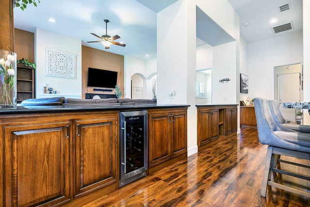 2639 Maine Ave, Clovis, CA 93619 - kitchen with beverage cooler, dark countertops, dark wood finished floors, a ceiling fan, and brown cabinetry