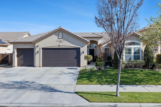 2639 Maine Ave, Clovis, CA 93619 - mediterranean / spanish home featuring a garage, stucco siding, concrete driveway, and a front lawn