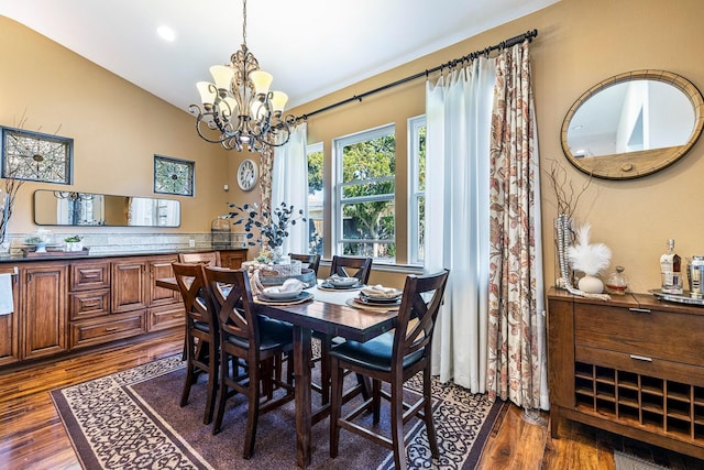 2639 Maine Ave, Clovis, CA 93619 - dining room with dark wood-style flooring, a chandelier, and vaulted ceiling