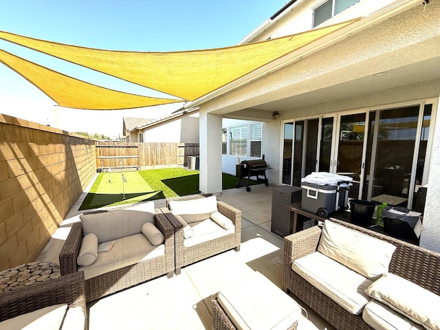 971 Dana Rd W, Madera, CA 93636 - fenced backyard featuring a patio area, outdoor lounge area, and area for grilling