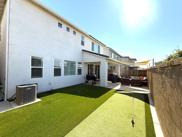 971 Dana Rd W, Madera, CA 93636 - back of house featuring an outdoor hangout area, a fenced backyard, a putting area, stucco siding, and a patio