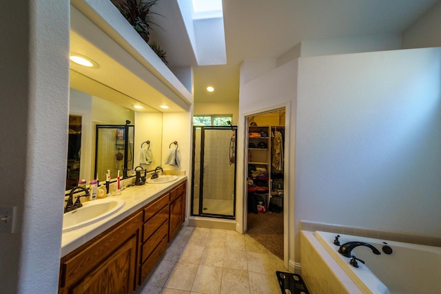 9930 N Rowell Ave, Fresno, CA 93720 - bathroom featuring a spacious closet, double vanity, a garden tub, tile patterned flooring, and a stall shower