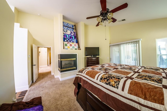 9930 N Rowell Ave, Fresno, CA 93720 - bedroom featuring light colored carpet, a multi sided fireplace, and ceiling fan