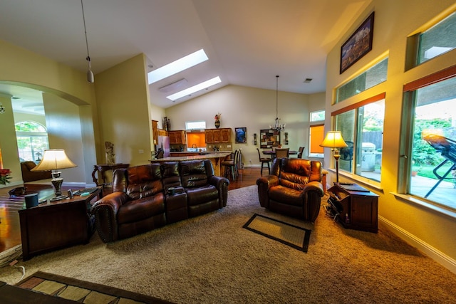 9930 N Rowell Ave, Fresno, CA 93720 - carpeted living room with plenty of natural light, a skylight, lofted ceiling, and arched walkways
