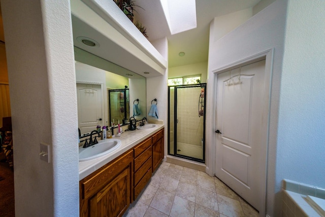 9930 N Rowell Ave, Fresno, CA 93720 - full bathroom with double vanity, a shower stall, a skylight, and tile patterned floors