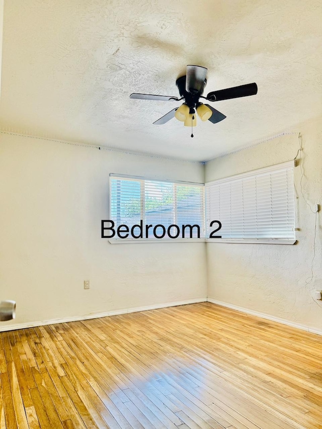 3646 E Dayton Ave, Fresno, CA 93726 - empty room with hardwood / wood-style flooring, ceiling fan, and a textured ceiling