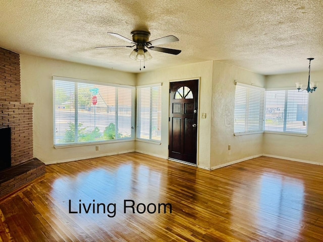 3646 E Dayton Ave, Fresno, CA 93726 - entrance foyer with wood finished floors, plenty of natural light, ceiling fan, a chandelier, and a textured ceiling