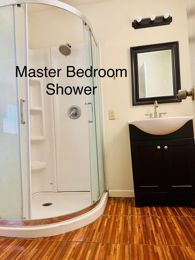 3646 E Dayton Ave, Fresno, CA 93726 - full bath featuring a shower stall, wood finished floors, and vanity