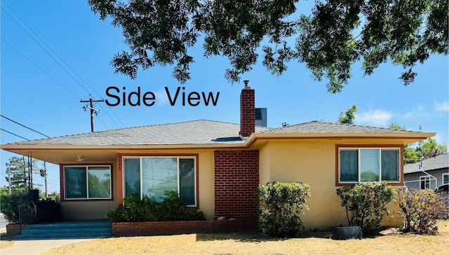 3646 E Dayton Ave, Fresno, CA 93726 - view of front of property featuring a chimney, stucco siding, and a shingled roof