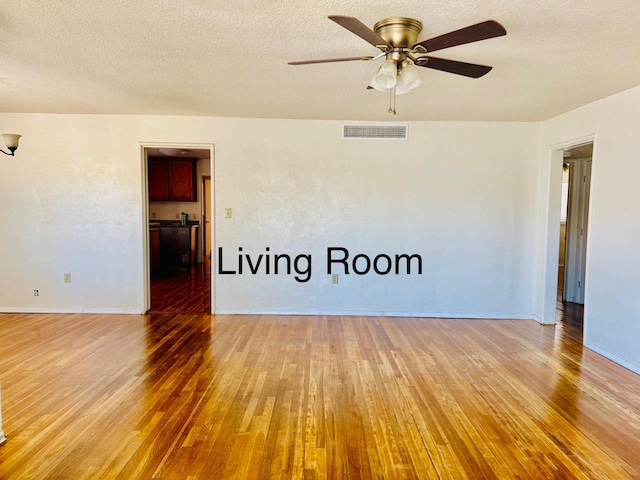 3646 E Dayton Ave, Fresno, CA 93726 - spare room featuring light wood-style flooring, a ceiling fan, and a textured ceiling