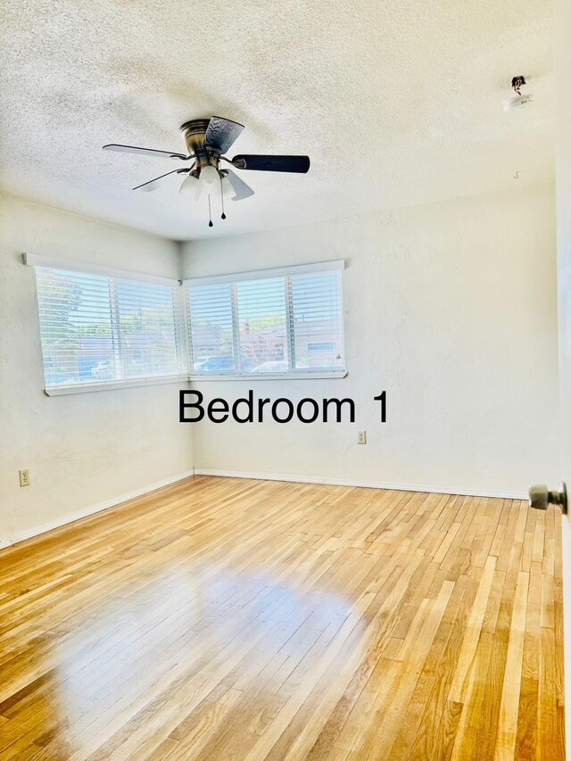 3646 E Dayton Ave, Fresno, CA 93726 - unfurnished room with hardwood / wood-style flooring, a textured ceiling, plenty of natural light, and a ceiling fan