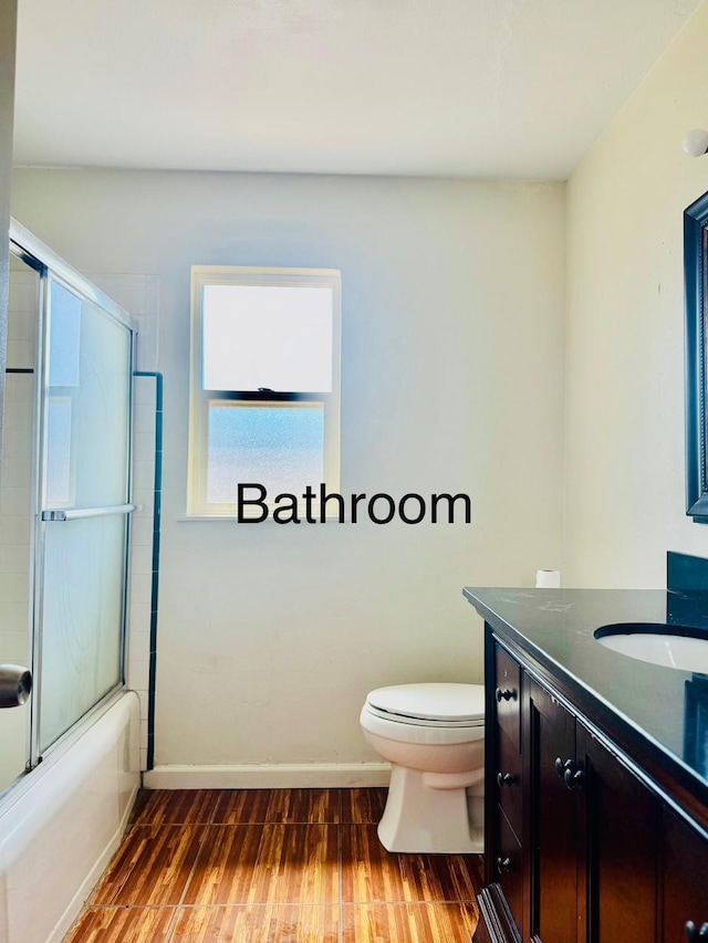 3646 E Dayton Ave, Fresno, CA 93726 - bathroom featuring vanity, wood finished floors, and bath / shower combo with glass door